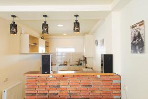 a kitchen with a brick counter with speakers at Gudauri private cottage in Gudauri
