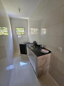 a bathroom with a sink and a shower at Mini Casa 02 em Cabo Frio in Cabo Frio