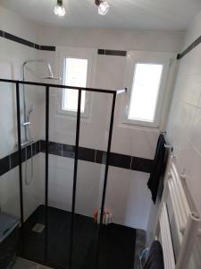 a bathroom with a shower with black and white stripes at Tourmalet in Campan