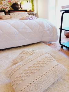 a bedroom with a white bed with a white rug at B&B La Delice in Dalmine +50 photos