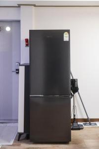a black refrigerator in a room with a camera at JB Stay#Hongdae & Sinchon 10min#Double Room in Seoul