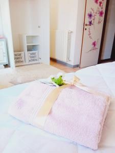 a pink blanket on top of a bed at B&B La Delice in Dalmine