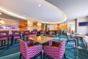 a restaurant with colorful chairs and tables and a bar at SpringHill Suites Arundel Mills BWI Airport in Hanover