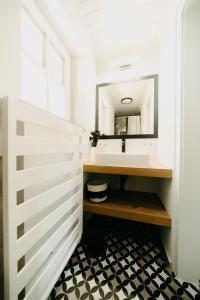 La salle de bains est pourvue d'un lavabo et d'un miroir. dans l'établissement seehaus ausZEIT, à Faak am See
