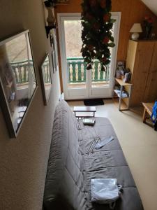 a living room with a couch and a christmas tree at Duplex Métabief in Métabief