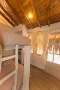 a room with two bunk beds and a window at Modern Appartments with private beach in Máncora