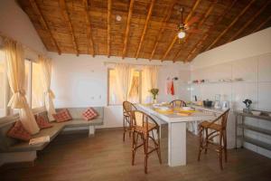 a kitchen with a table and chairs and a couch at Modern Appartments with private beach in Máncora