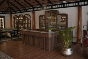 a bar in a room with a potted plant at Regenta Resort Sakleshpur in Sakleshpur