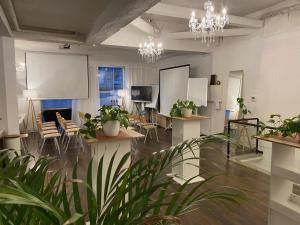 a large room with chairs and potted plants in it at Superschönes Studio LUNCA 220qm in Stuttgart West in Stuttgart