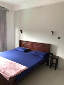 een slaapkamer met een bed met blauwe lakens en een tafel bij Sun Villa 