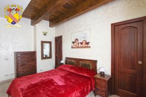 um quarto com uma cama com uma colcha vermelha em Dal centurione em Roma