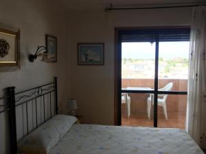 a bedroom with a bed and a view of a balcony at Roquemar dreams 523 in Roquetas de Mar