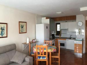 a kitchen and a living room with a table and a couch at Roquemar dreams 523 in Roquetas de Mar