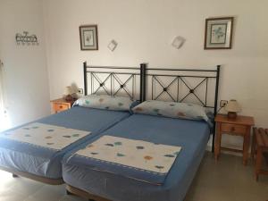 a bedroom with a blue bed with two pillows at Roquemar dreams 613 in Roquetas de Mar