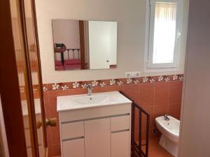 a bathroom with a sink and a toilet and a mirror at Roquemar dreams 435 in Roquetas de Mar