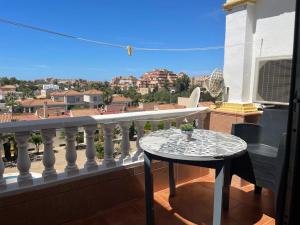 a table on a balcony with a view of a city at Roquemar dreams 435 in Roquetas de Mar