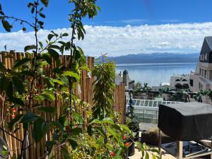 a balcony with a fence and a view of the water at MINI LOFT Departamentos Bariloche in San Carlos de Bariloche