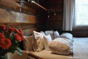 a bedroom with a bed with pillows and a window at Willa Marma B&B in Zakopane