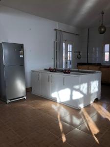 a kitchen with a white counter and a refrigerator at Das! Haus am Meer in Safaga