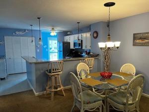 a kitchen and dining room with a table and chairs at Colony III 203 Condo in Myrtle Beach