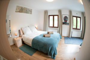a bedroom with a large bed and two windows at The Ring Inn in Adenau