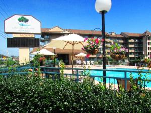 a resort with a swimming pool and a hotel at Arbors at Island Landing Hotel & Suites in Pigeon Forge
