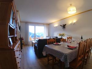 a dining room with a table and a living room at Soldeu Paradis Soldeu in Soldeu
