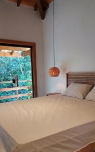 sypialnia z dużym łóżkiem i oknem w obiekcie Casa Trancoso Refúgio w mieście Trancoso