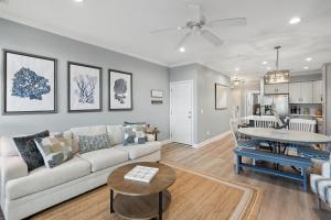 a living room with a couch and a table at 21 Turtle Bay Carolina Tides in Folly Beach