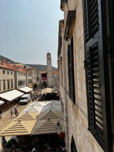 a street with a group of umbrellas in a city at Studio Apartments Stradun in Dubrovnik