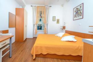 Ένα ή περισσότερα κρεβάτια σε δωμάτιο στο Studio Apartments Stradun