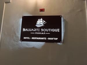 a sign on a wall with a ship on it at HOTEL BALUARTE BOUTIQUE PANAMA in Panama City