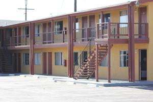 un bâtiment avec un escalier sur son côté dans l'établissement Cinderella Motel, à Wasco