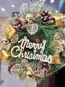 a christmas wreath with a merry christmas sign at THE K HOTEL in Dubai