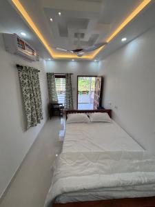 a bedroom with a large bed in a room at Mali Homestays in Cochin
