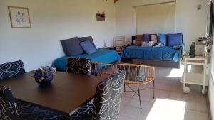 a living room with a table and a couch at Casa costanera Lago Buenos Aires, Los Antiguos in Los Antiguos +8 photos