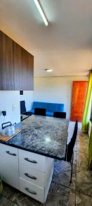 a kitchen with a counter top in a room at Departamentos y Tinajas BlancaMahuida in El Quisco