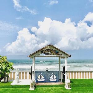 a gazebo in front of the beach at Pele's Fisherman Beach Stay in Benaulim