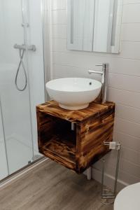 a bathroom with a white sink and a mirror at Wolds Wine Estate 