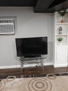 a flat screen tv sitting on a table in a living room at MJD Havens in Washington