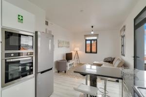 a kitchen and living room with a stainless steel refrigerator at Lazareto Apartment by HR Madeira in Funchal