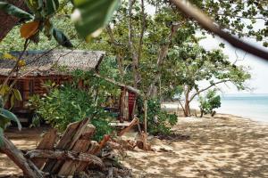 a house on the beach next to the ocean at Simple Life Bungalows in Ko Jum