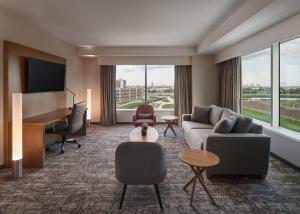 a hotel room with a couch and a piano at Great Canadian Casino Resort Toronto in Toronto