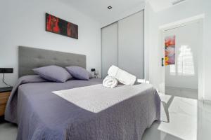 - une chambre avec un grand lit et des draps violets dans l'établissement La Villa del Roc, à Roda de Bará