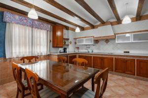 a kitchen with a wooden table and wooden chairs at Villa Soler House in Malaga by Costarentals - MAL03 in Málaga