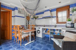 a kitchen with blue and white walls and a table and chairs at Villa Soler House in Malaga by Costarentals - MAL03 in Málaga
