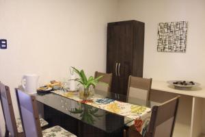 a dining room with a glass table and chairs at AP 41- Apart OH in Ciudad del Este