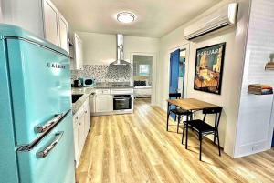 a kitchen with a blue refrigerator and a table at Luxury 1 BR Montrose - Cagliari at The Italian Plaza in Houston