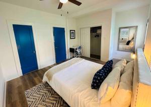 a bedroom with a large bed with blue doors at Luxury 1 BR Montrose - Cagliari at The Italian Plaza in Houston