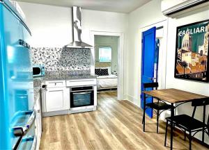 a kitchen with a stove and a table with a dining room at Luxury 1 BR Montrose - Cagliari at The Italian Plaza in Houston